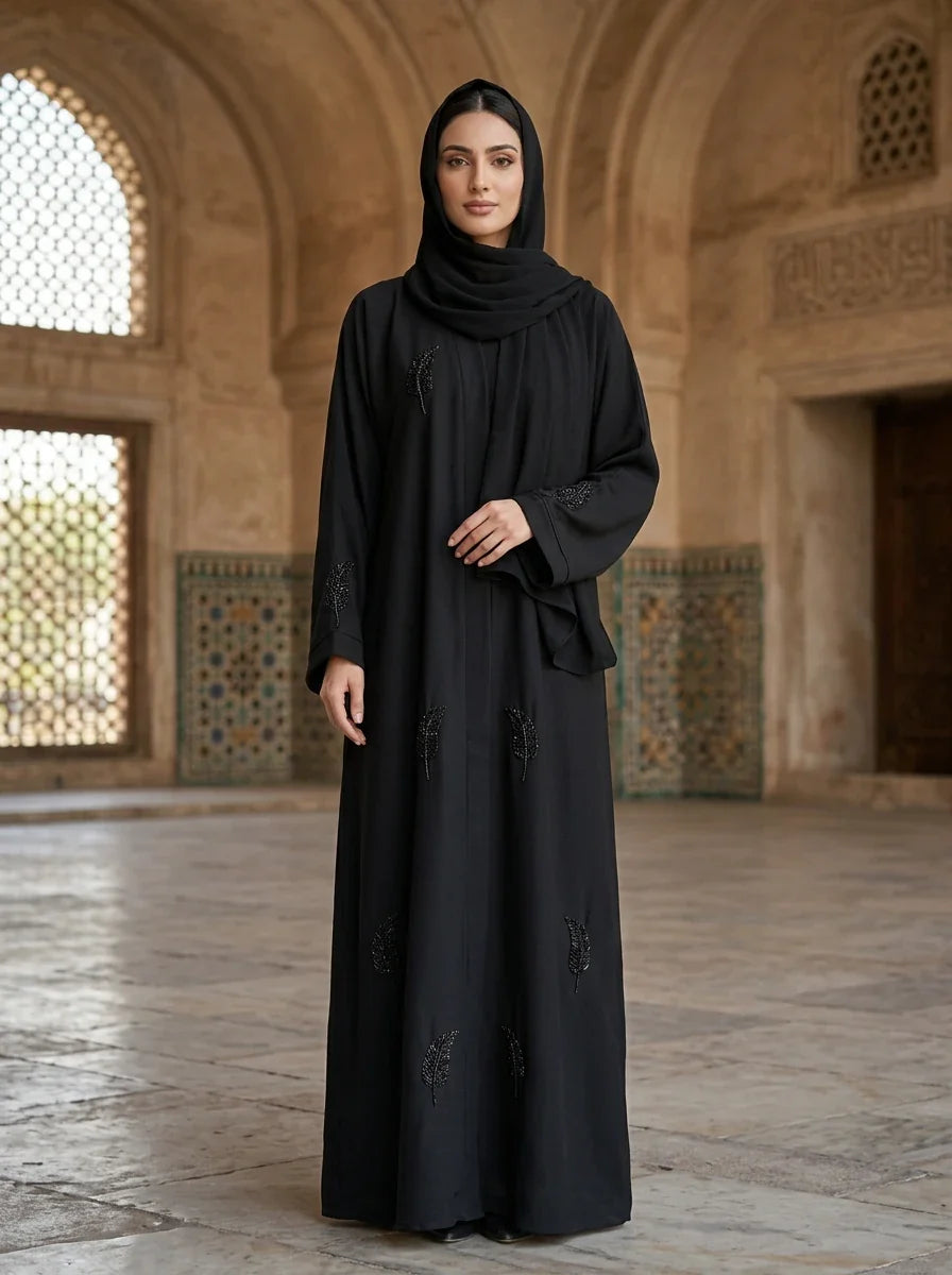 Mishal Abaya in Black — cape front with scattered beaded feather motifs, front view