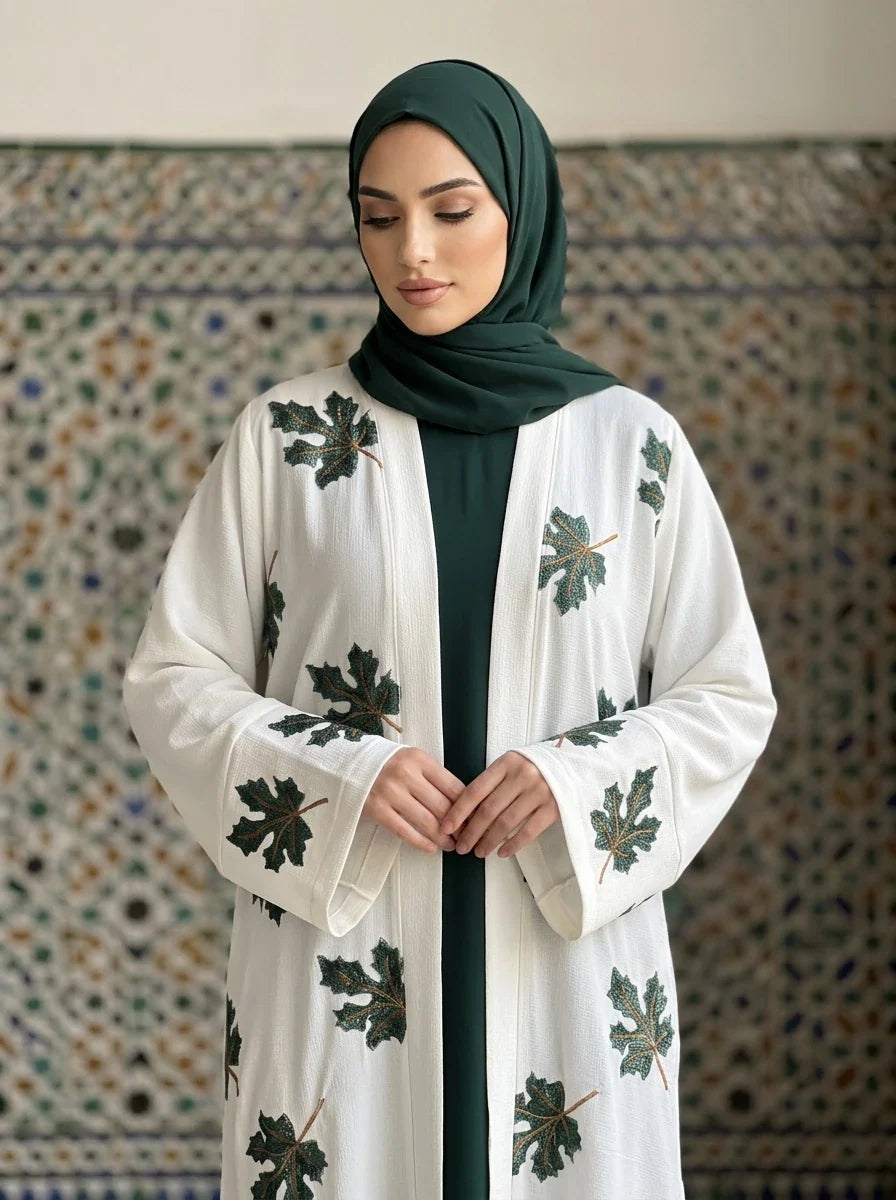Model wearing Zimal Abaya, front view with embroidery detail