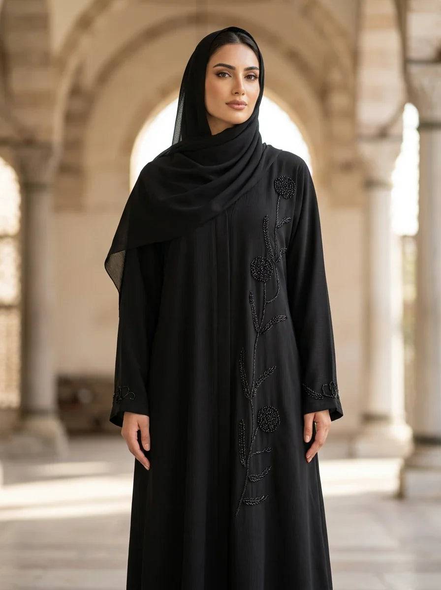 Noreen Abaya in Black — beaded floral vine down the center front, front view
