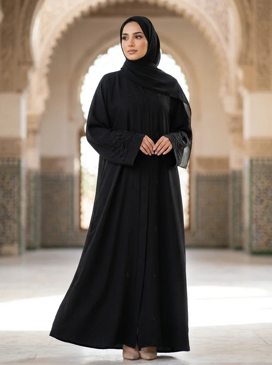 Palwasha Abaya in Black — beaded leaf-embroidered cuffs, front button placket, front view
