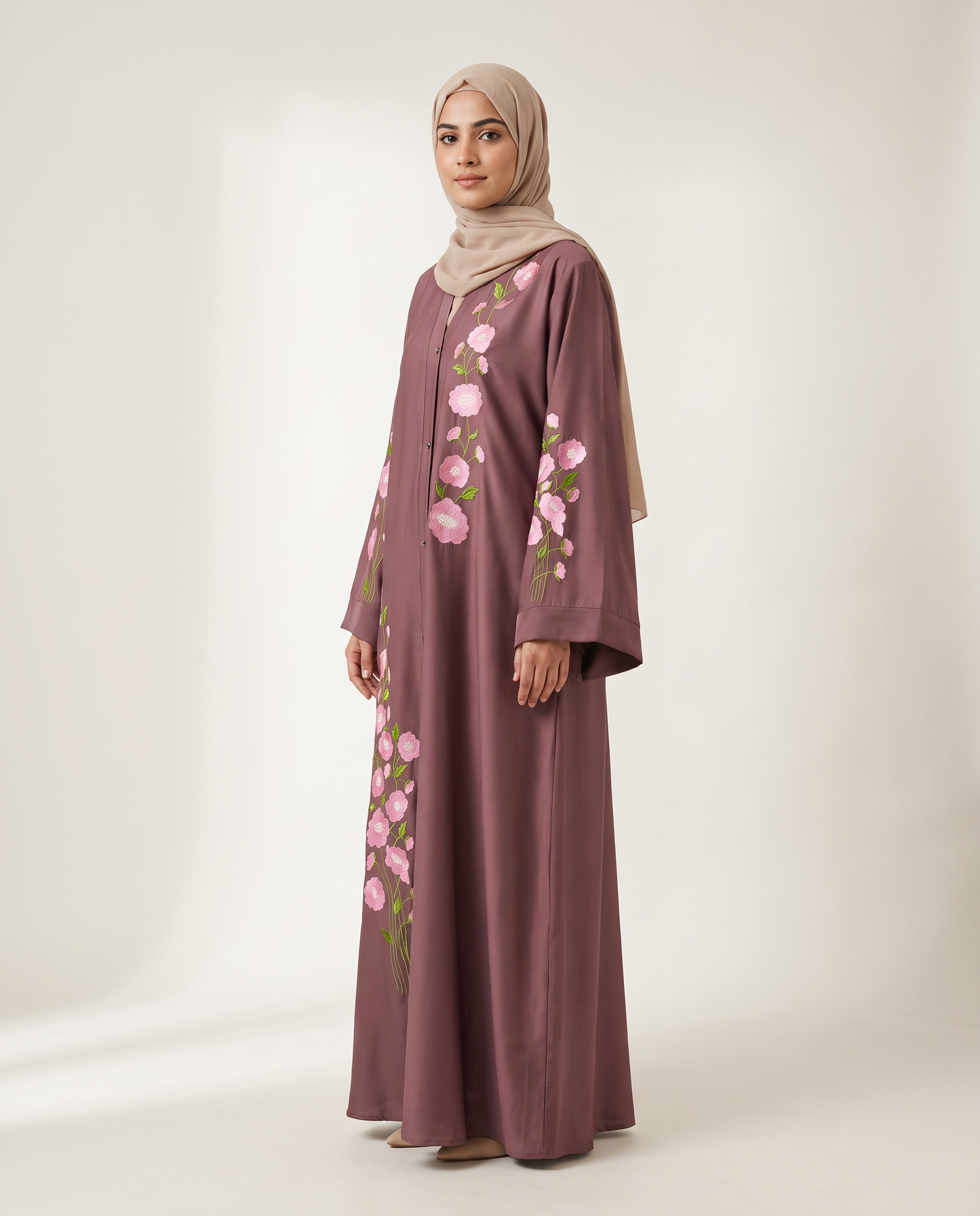 Zainab Abaya side profile view, flowing mauve Nida silhouette with pink floral embroidery trail