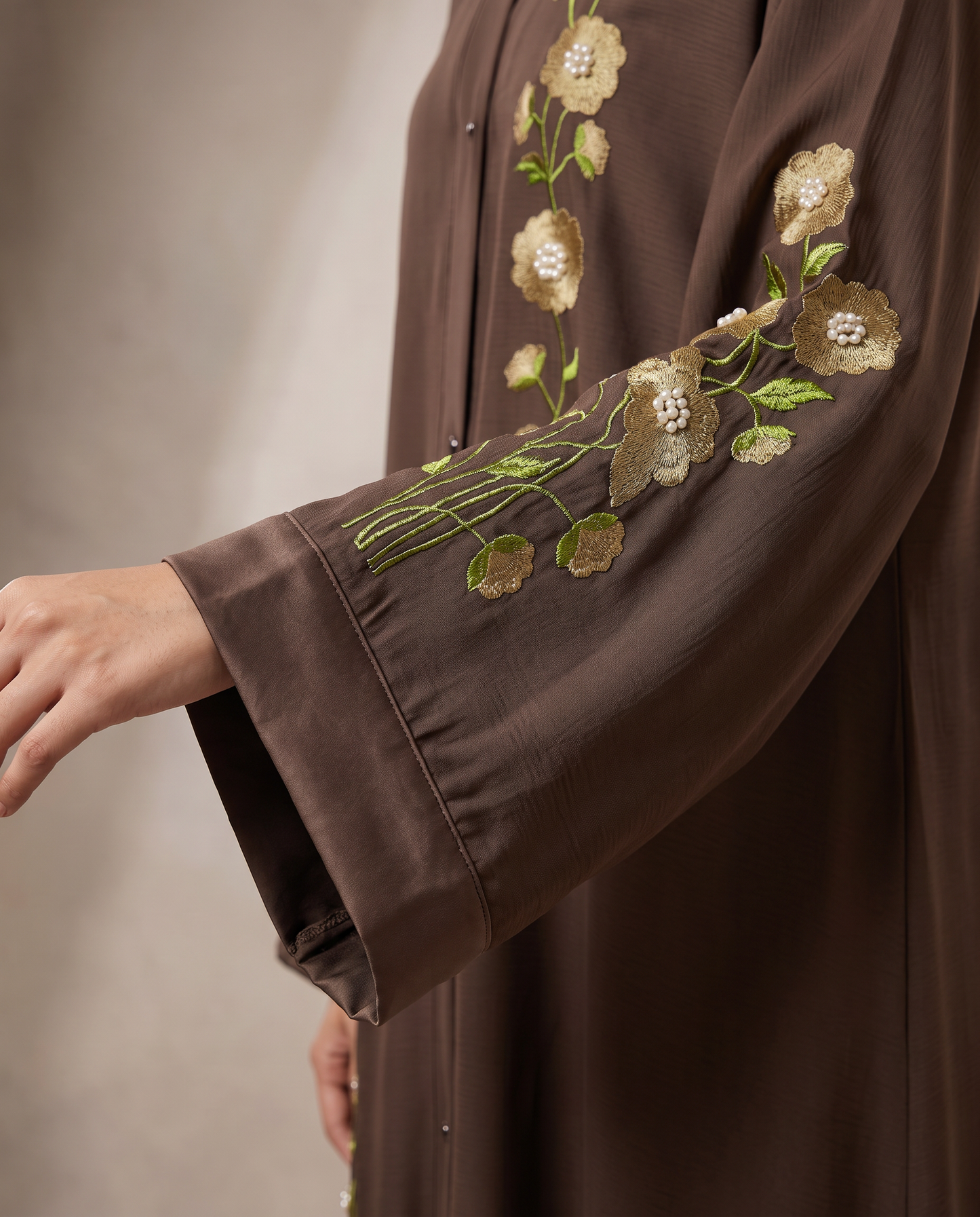 Close-up of wide sleeve and cuff with gold floral embroidery on Hiba abaya